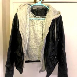 Built in fur sweater leather jacket. Exterior is black with gray on the inside.